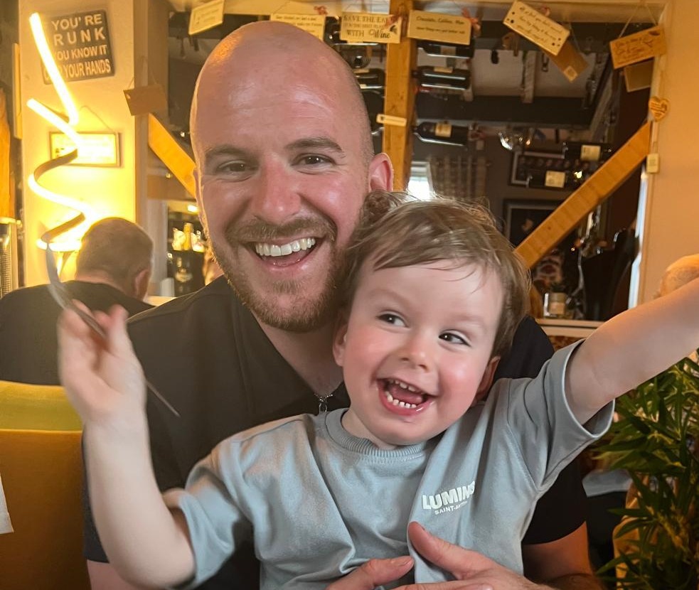 A former research patient with his young son