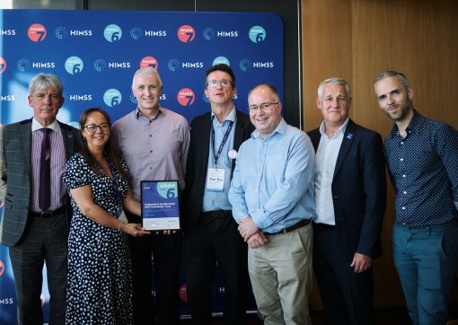 A group of our colleagues holding the award with some of the HIMMS Team