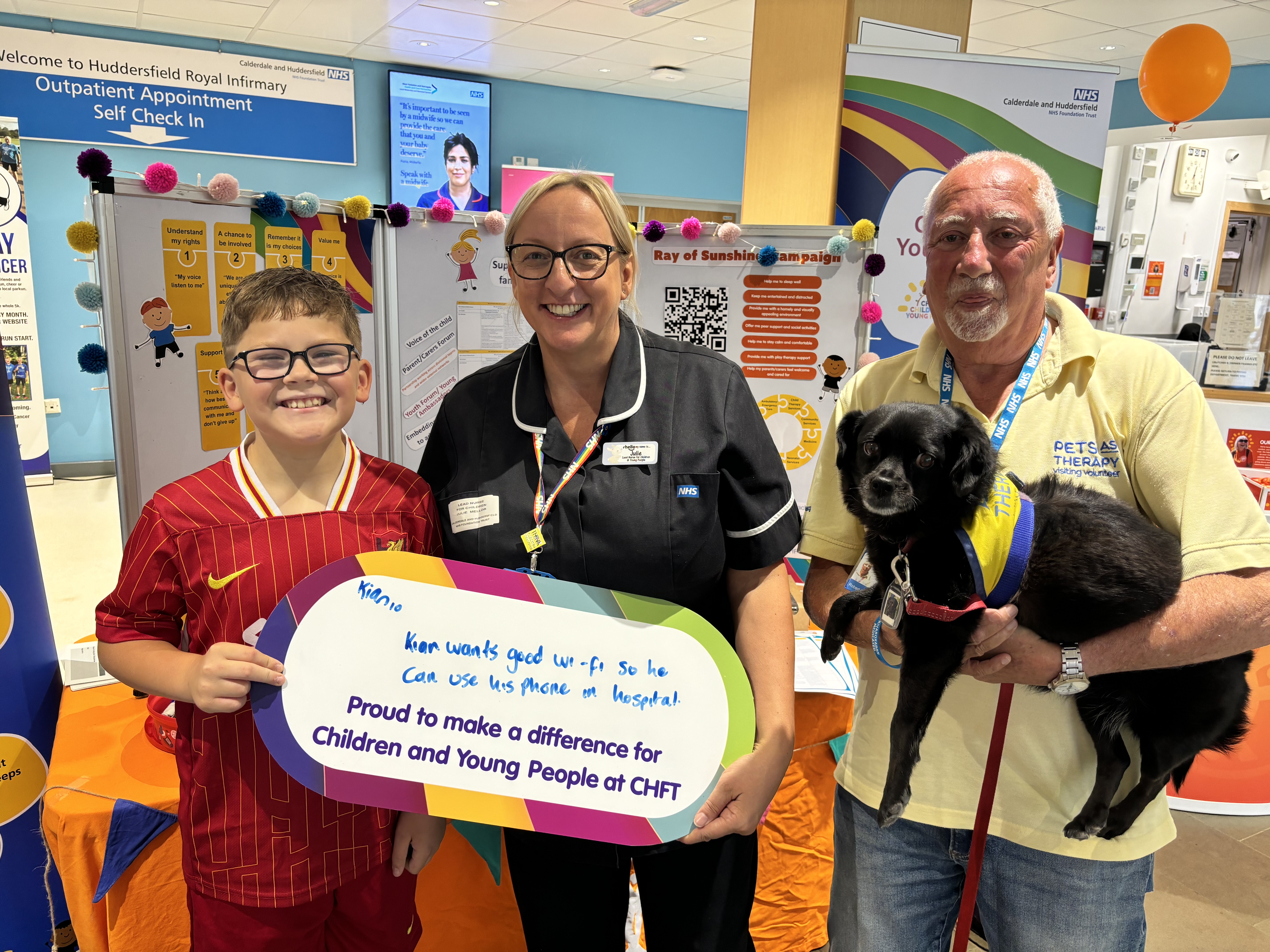 Julie with 10-year old Kian, Non-Executive Director Robert Markless and PAT dog Daisy