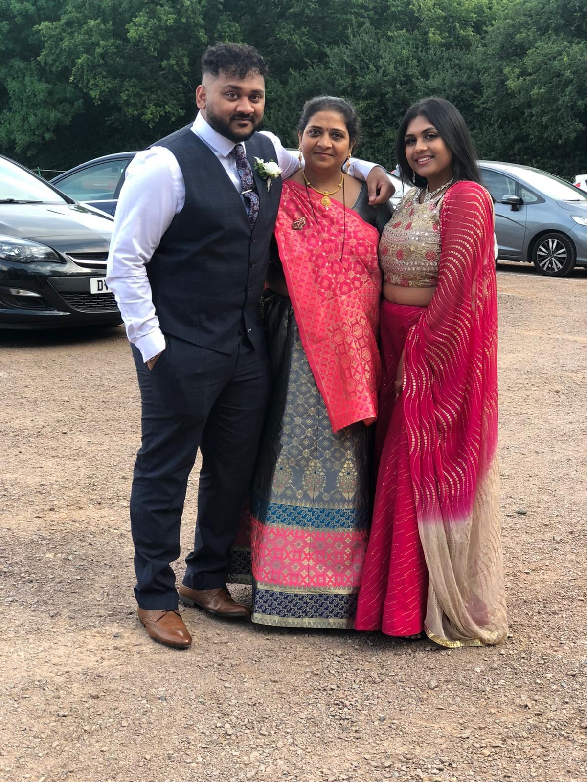 Mamta in the middle in traditional wedding attire, with son Ricky left and daughter Bhrati, right