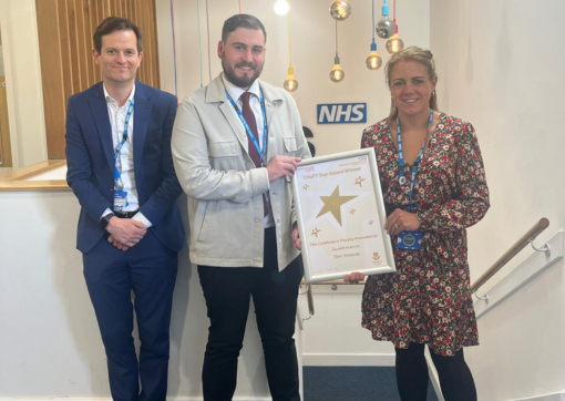 Rob Aitchison presenting the Award to Oliver and Charlotte