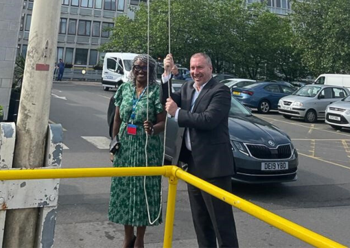 Brendan Brown and Denise Sterling raise the Windrush Flag at HRI