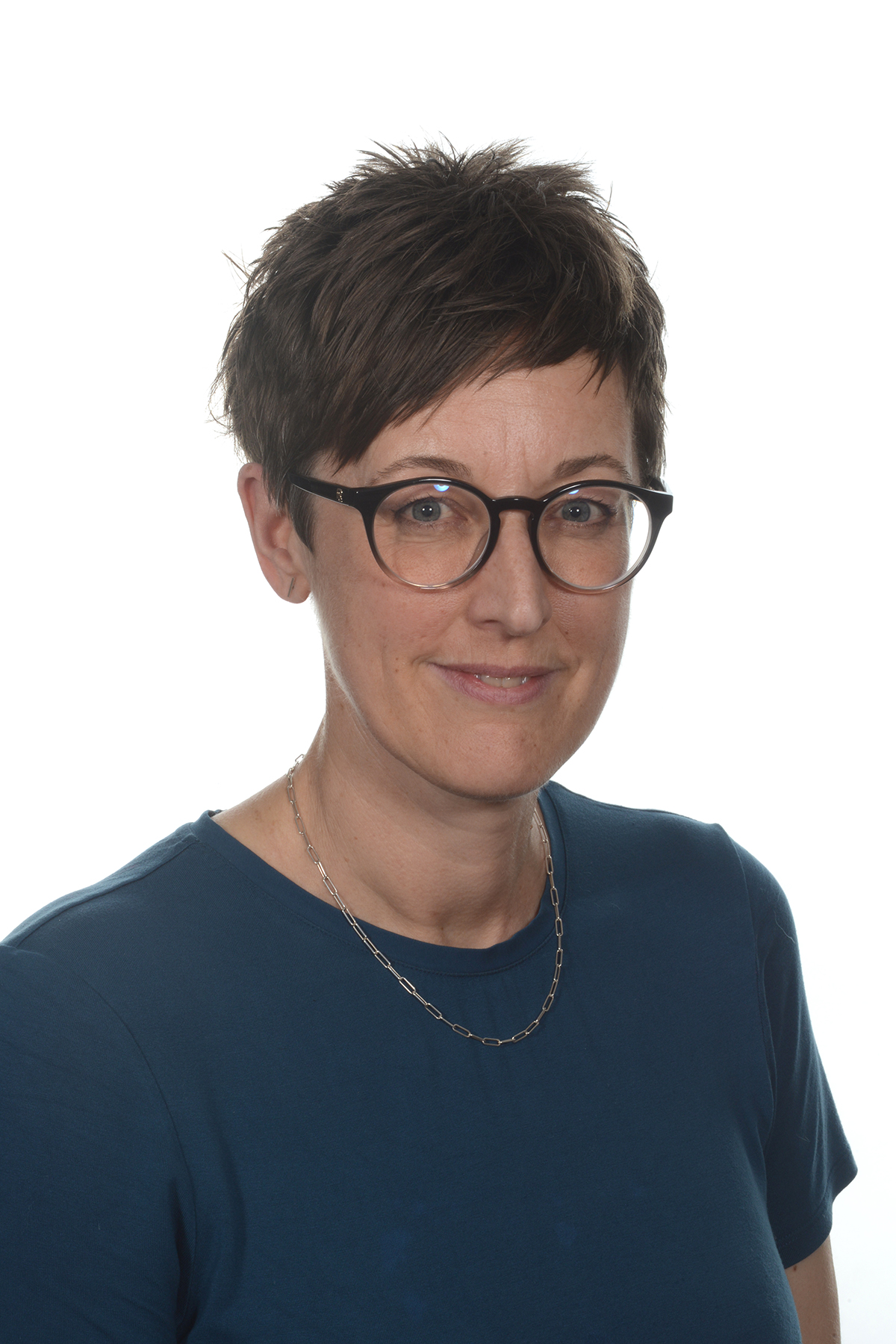 A person wearing glasses and a blue top.