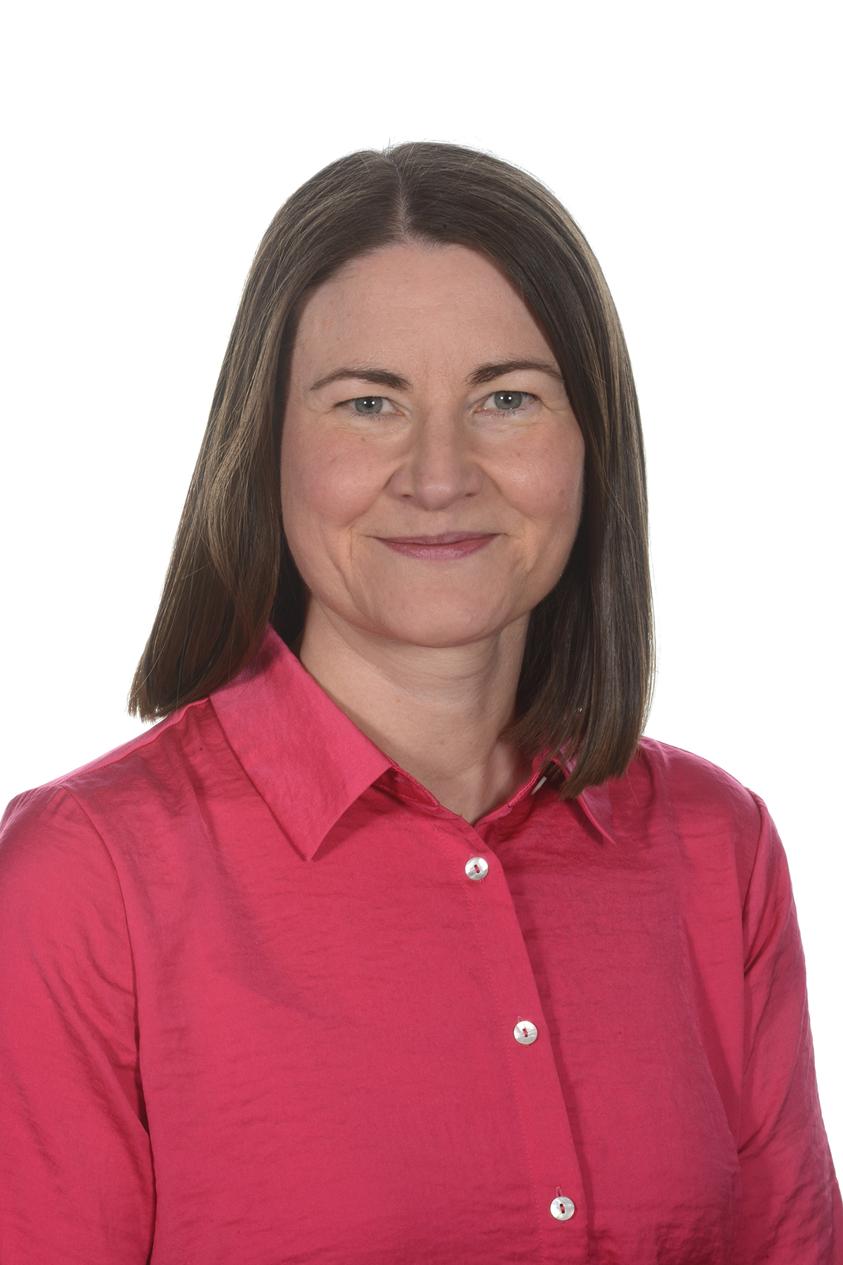 A person with brown hair and in a pink shirt