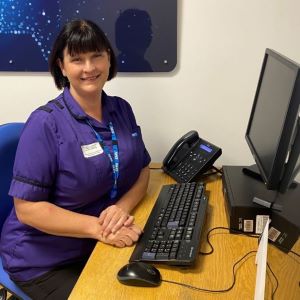 Helen sat working at a desk