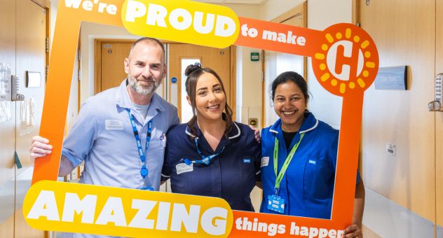 Three of our colleagues with our Charity's selfie frame