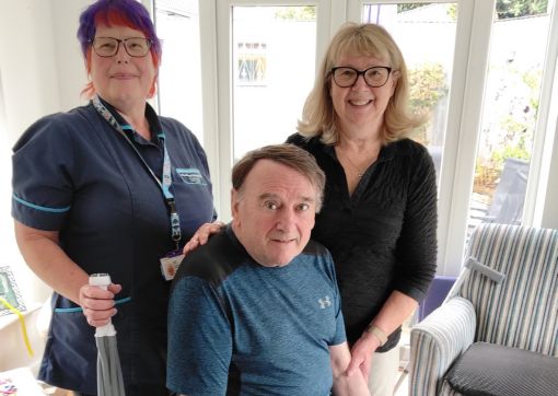 Falls prevention Assistant practitioner, Lisa Gray, helping bob and his wife Sue