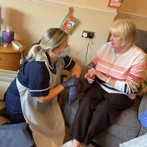 Image of a patient receiving care at home from a district nurse