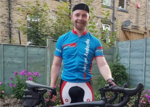 Mike with his bike before his diagnosis