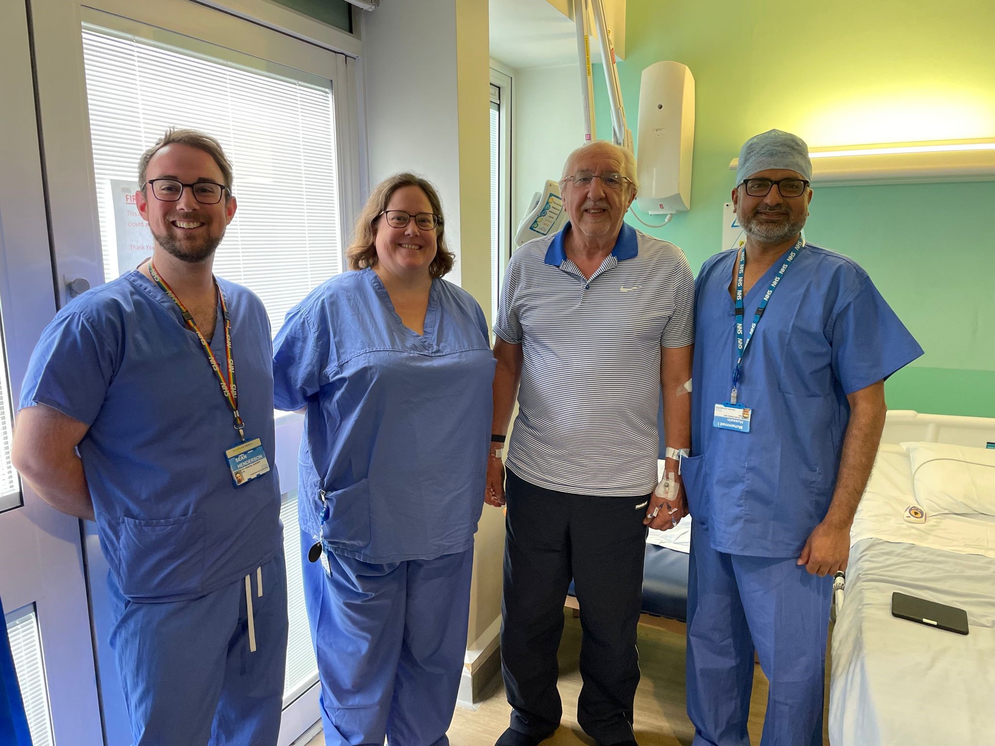 Ken is up and about after surgery. Pictured with the surgical team. 
