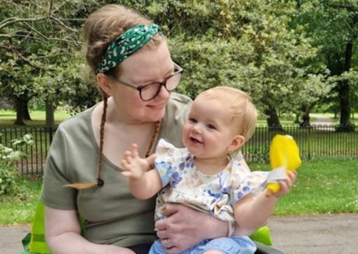 Sarah holding her daughter