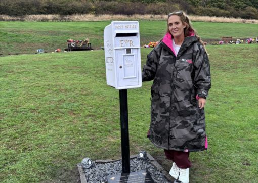 Sherly next to the new post box in the crematorium