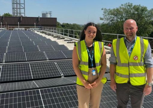 Grace and Dan with the installed solar panels at HRI