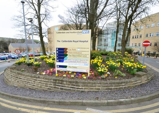 Image of the roundabout leading to the main entrance at Calderdale Royal Hospital, with signage in foreground