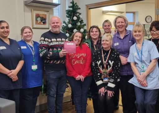 Paul and Jane (third and fourth from left) making their donation