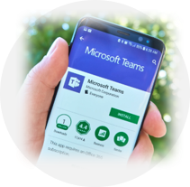 A hand holding a mobile phone, showing Micrsosoft Teams in Google Play