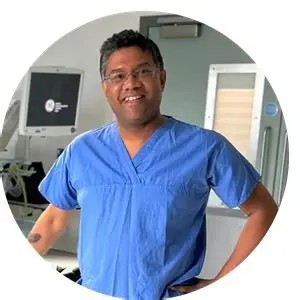 Mr Saha stood smiling with his hands on his waist