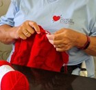 Woman knitting a red blanket for a baby