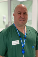 Mark Davies in green scrubs
