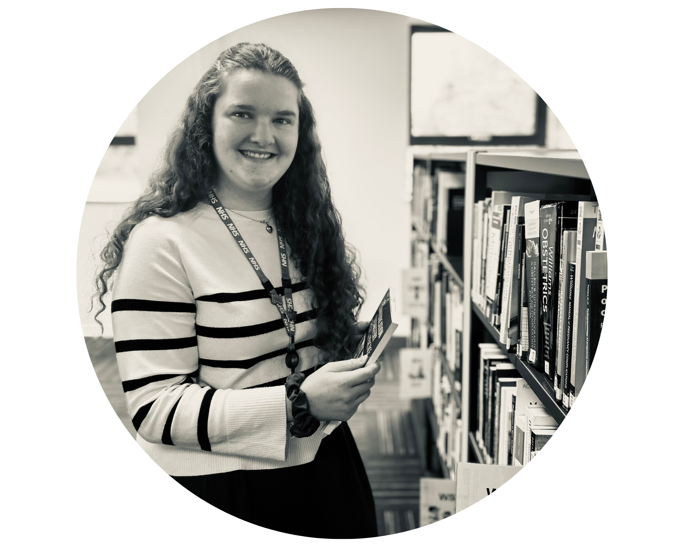 Black and white photo of Senior Library Technician Hannah holding a book.