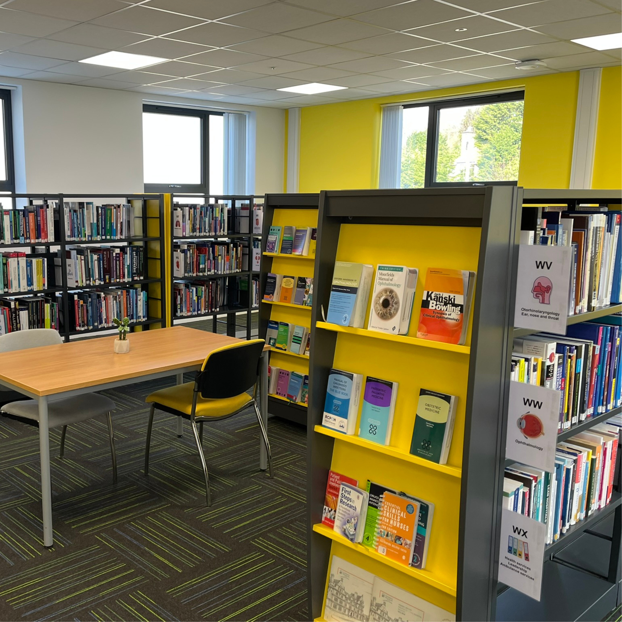 A photo of the bookshelves and study space in the library.