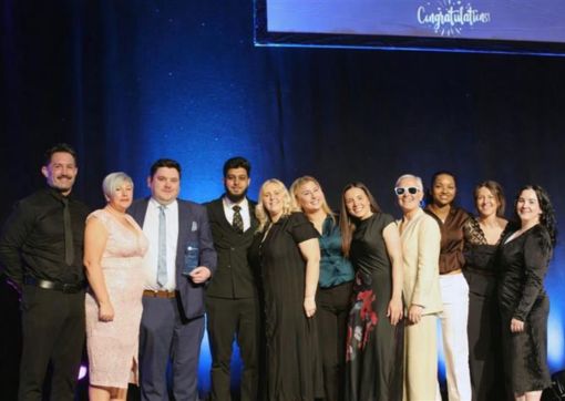 The BLOSM team on stage collecting their award