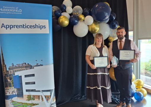 A photo of James (right) and Charlie (left) with their awards