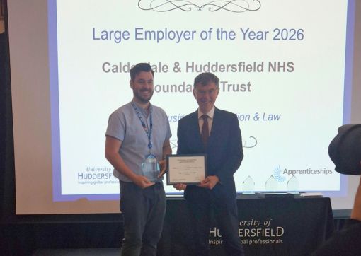 A photo of James Teal collecting the award 