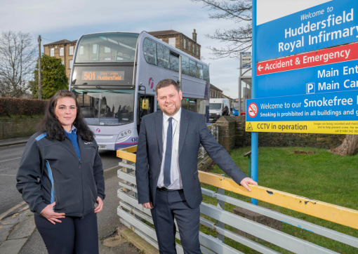 First Bus Operations Manager Craig Turner stands with driver Katharina Vanderstock outside Huddersfield Royal Infirmary 