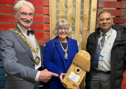 Senior Estates Officer, Jammal Mohammed, stands with the Mayor and Mayoress of Halifax at the event. The Mayoress is holding a wooden bird box made by Men in Sheds