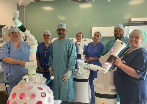 Some of our surgical colleagues stand with Versius the robot